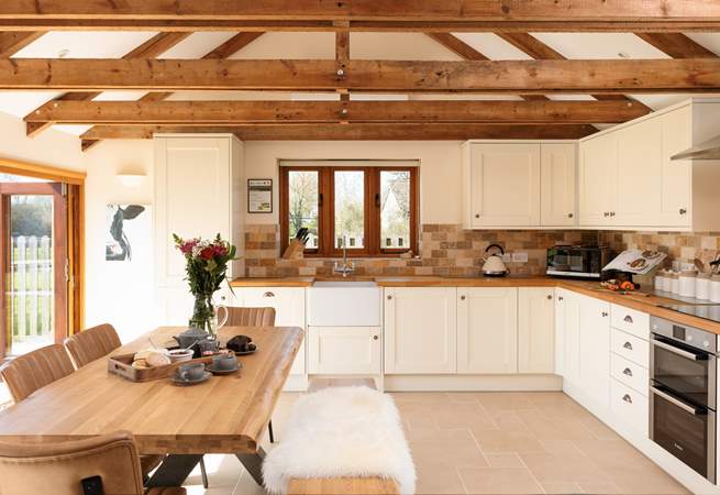 The kitchen is fitted around two walls at the far end of the ground floor. It is superbly equipped for you.