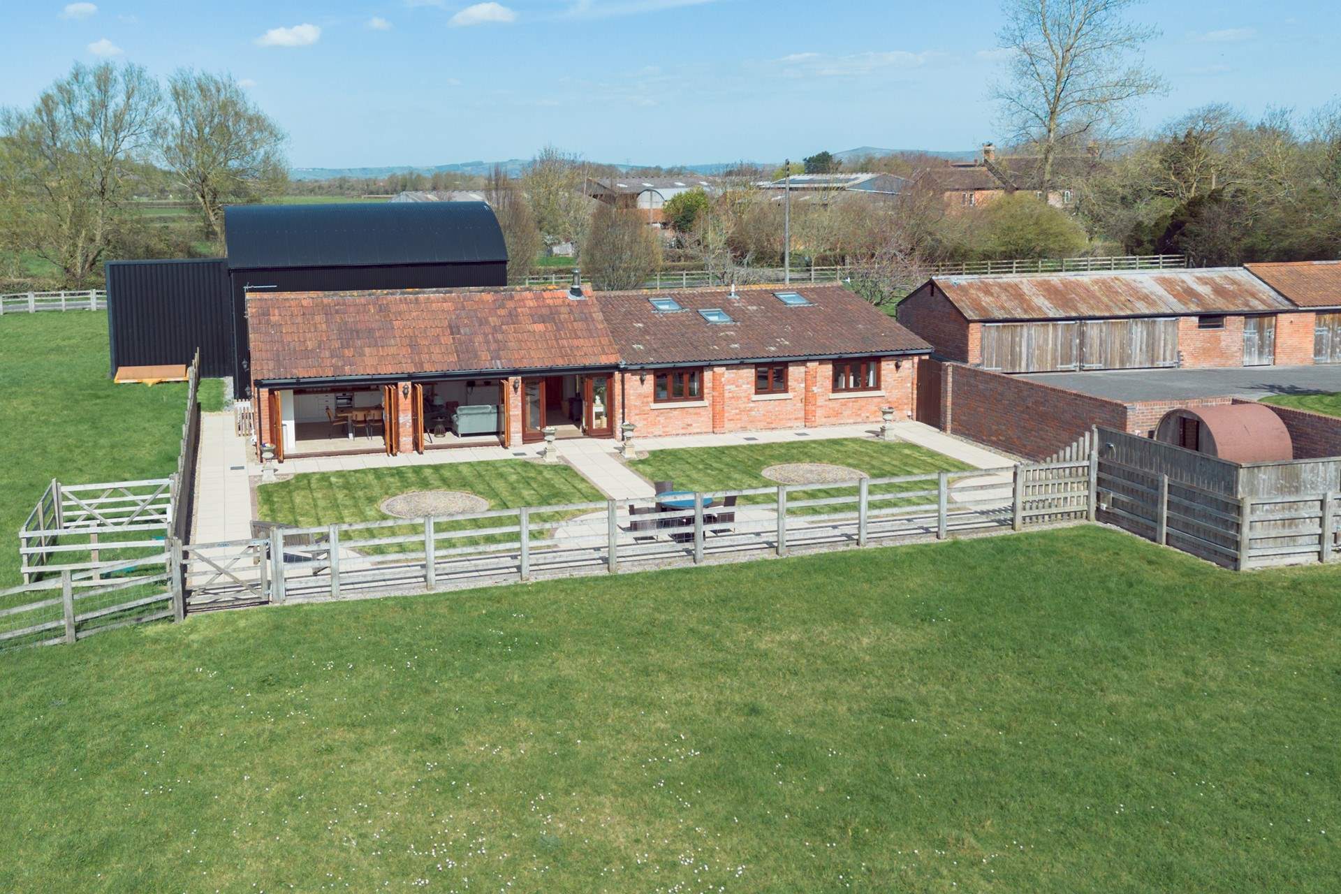 This aerial view shows The Old Barn, sauna and hot tub area to the far right hand side and Dutch barn to the rear where there is parking for guests.