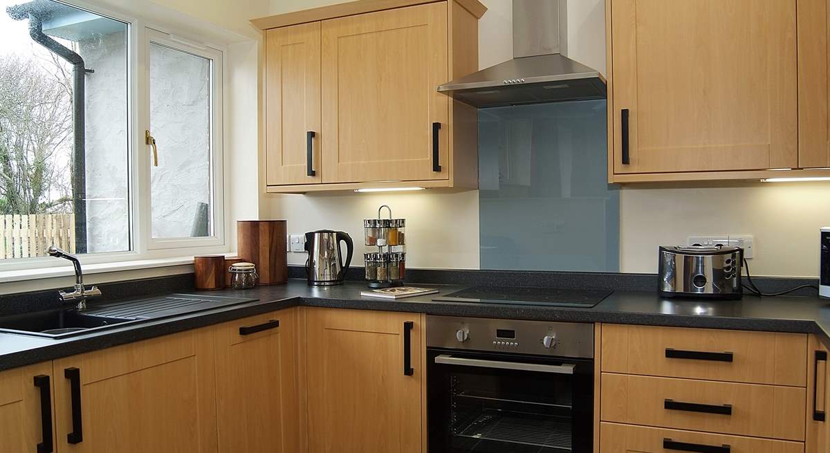 Three steps lead down to the kitchen-area, which looks out over the enclosed garden.