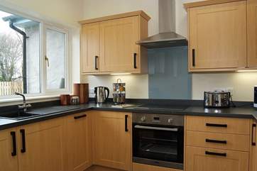 Three steps lead down to the kitchen-area, which looks out over the enclosed garden.