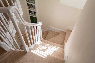 The stairs which wind down to the ground floor from the first floor landing.