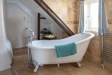 The en suite to bedroom three offers this rather delightful roll-top bath.