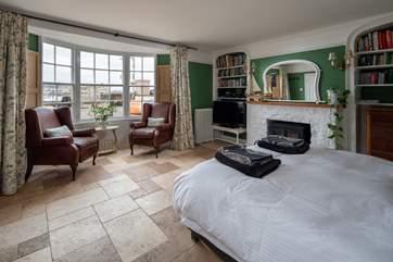The bedroom offers everything you could possibly need, a TV, coal-effect electric fire, comfy seating and perfect views out over the beach and water.