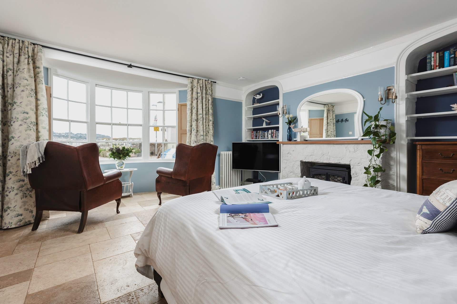 The bedroom offers everything you could possibly need, a TV, coal-effect electric fire, comfy seating and perfect views out over the beach and water.