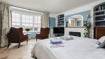 The bedroom offers everything you could possibly need, a TV, coal-effect electric fire, comfy seating and perfect views out over the beach and water.