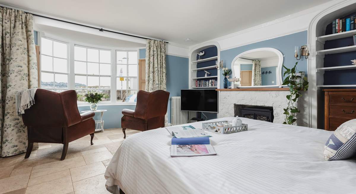 The bedroom offers everything you could possibly need, a TV, coal-effect electric fire, comfy seating and perfect views out over the beach and water.