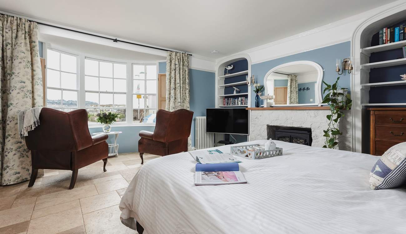 The bedroom offers everything you could possibly need, a TV, coal-effect electric fire, comfy seating and perfect views out over the beach and water.