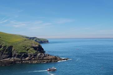 A fishing boat heads out to sea.
