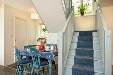 The painted cottage stairs lead to the 2 bedrooms.