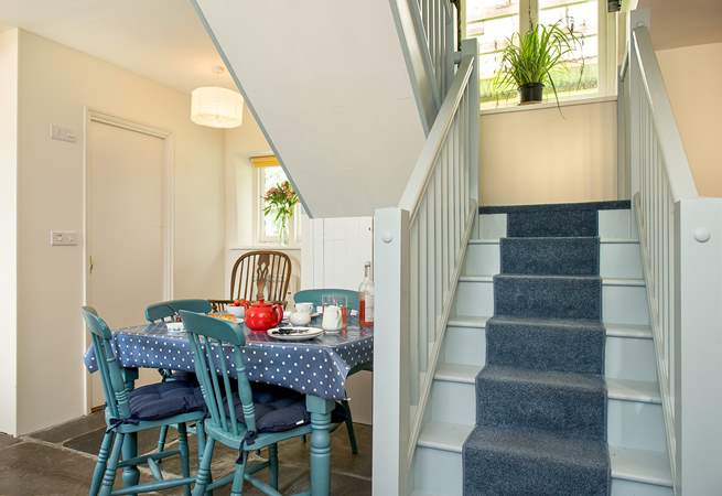 The painted cottage stairs lead to the 2 bedrooms.
