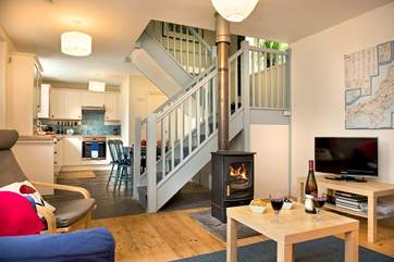 The stairs divide the sitting-area from the kitchen/dining-area.