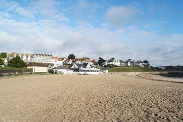 Looking from the end of Gyllyngvase beach towards the popular beach cafe with Falmouth seafront behind.