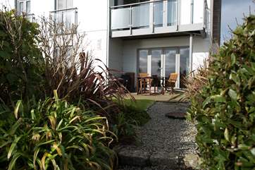 The patio offers a sheltered spot for sitting outside.