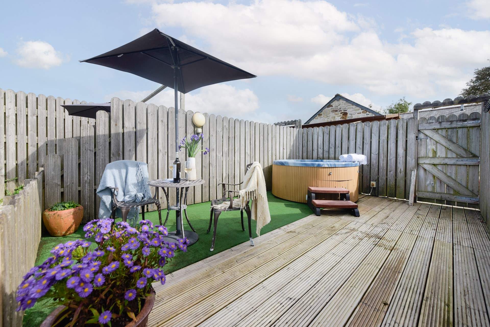 The private hot tub space has meadow views and a sundeck.