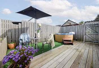 The private hot tub space has meadow views and a sundeck.