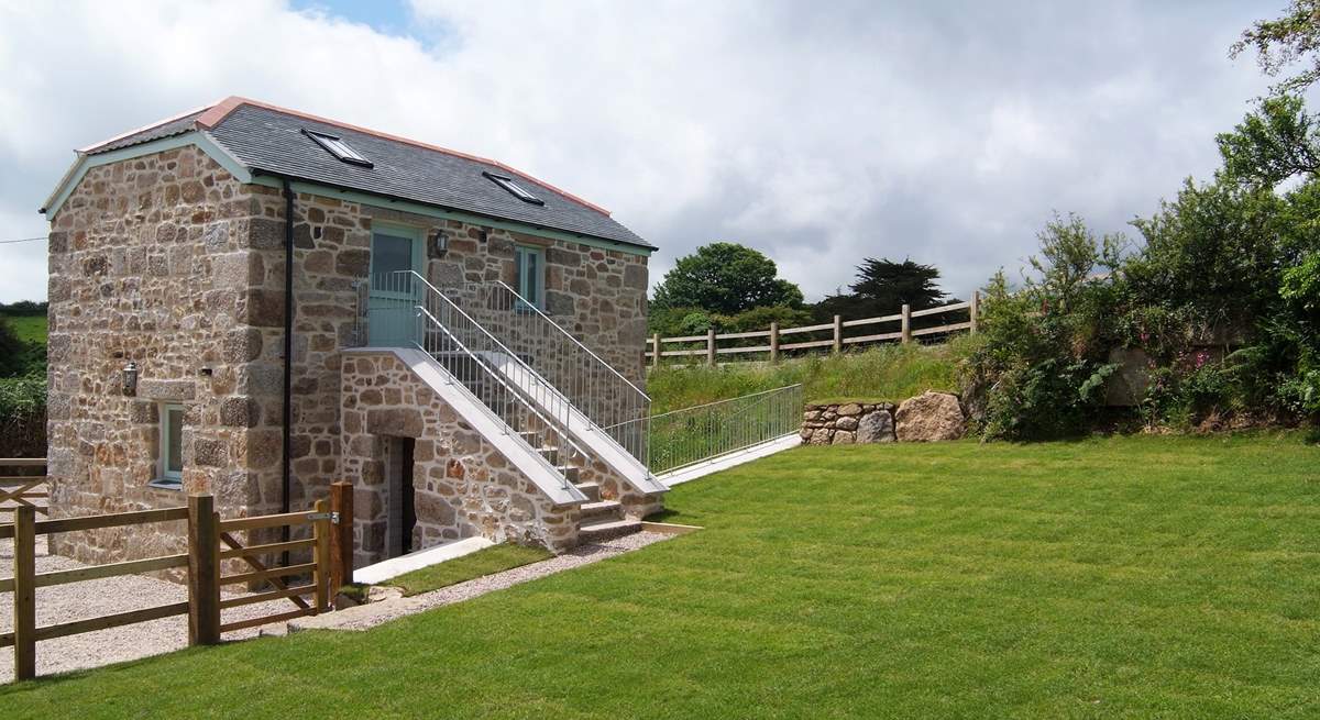 Steps lead down from the first floor living-area to the enclosed garden.