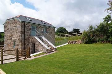 Steps lead down from the first floor living-area to the enclosed garden.
