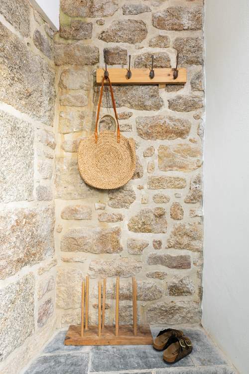 The stone cottage has an entrance porch to leave your sandy shoes behind.