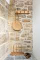 The stone cottage has an entrance porch to leave your sandy shoes behind.