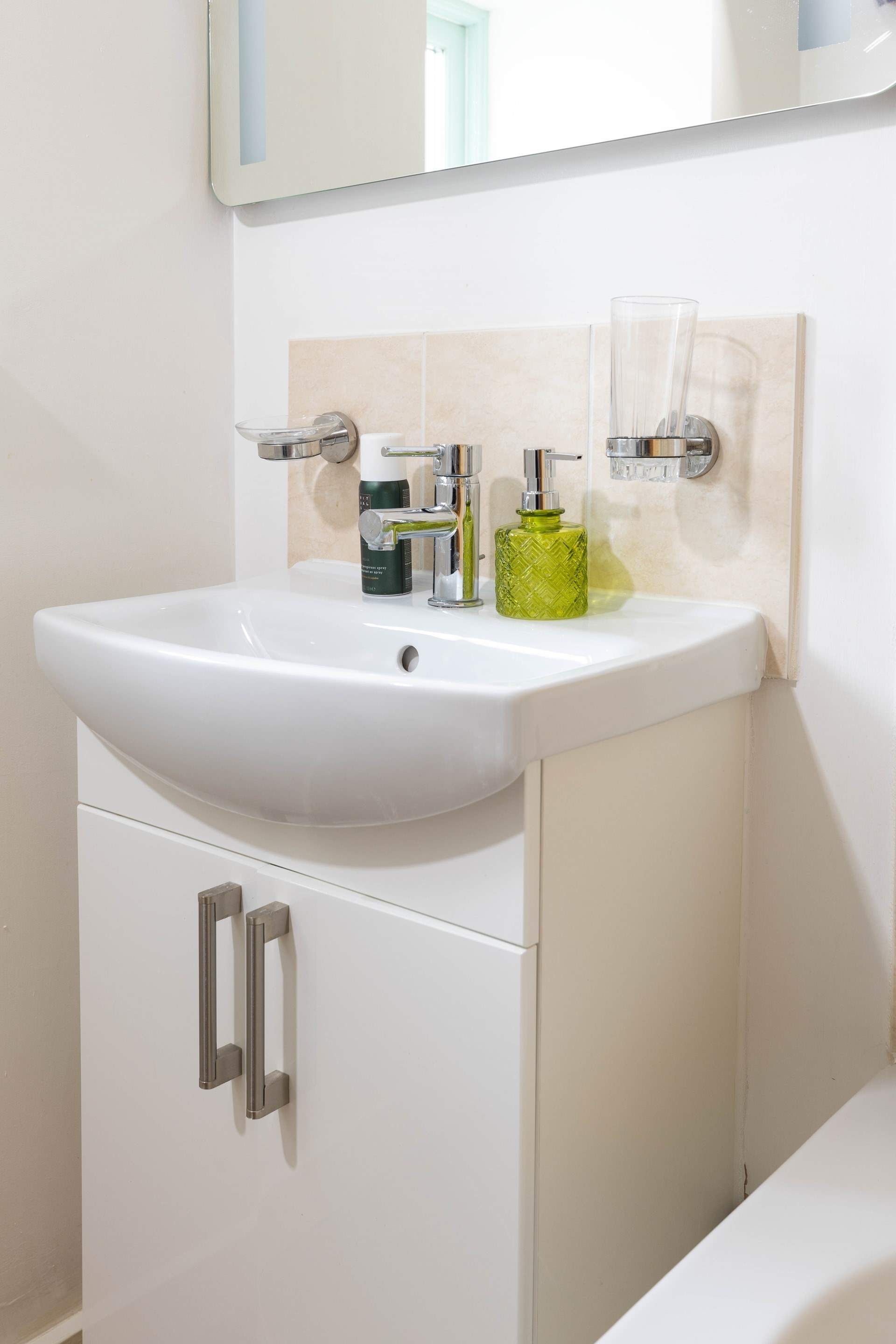 A very modern bathroom completes this pretty cottage.