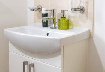 A very modern bathroom completes this pretty cottage.