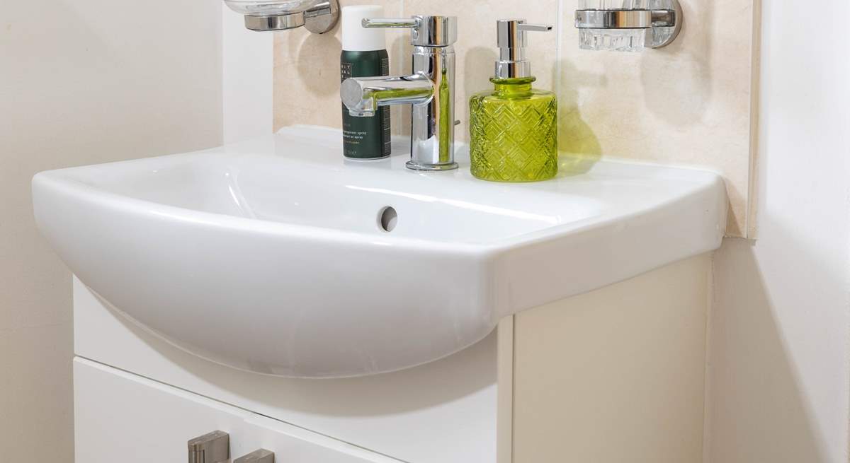 A very modern bathroom completes this pretty cottage.