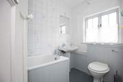 The very charming bathroom, with bath and fitted shower.