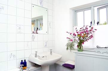 The bathroom has a bath and a fitted shower.