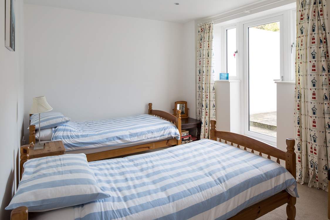 The second twin bedroom also has a door leading out into the garden area.