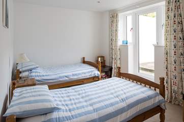 The second twin bedroom also has a door leading out into the garden area.