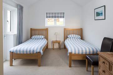 The twin bedroom has a door out to the raised garden at the back of the house.