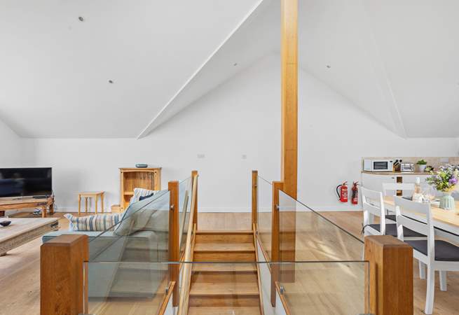 The open plan living area on the first floor is accessed via this lovely wooden staircase.