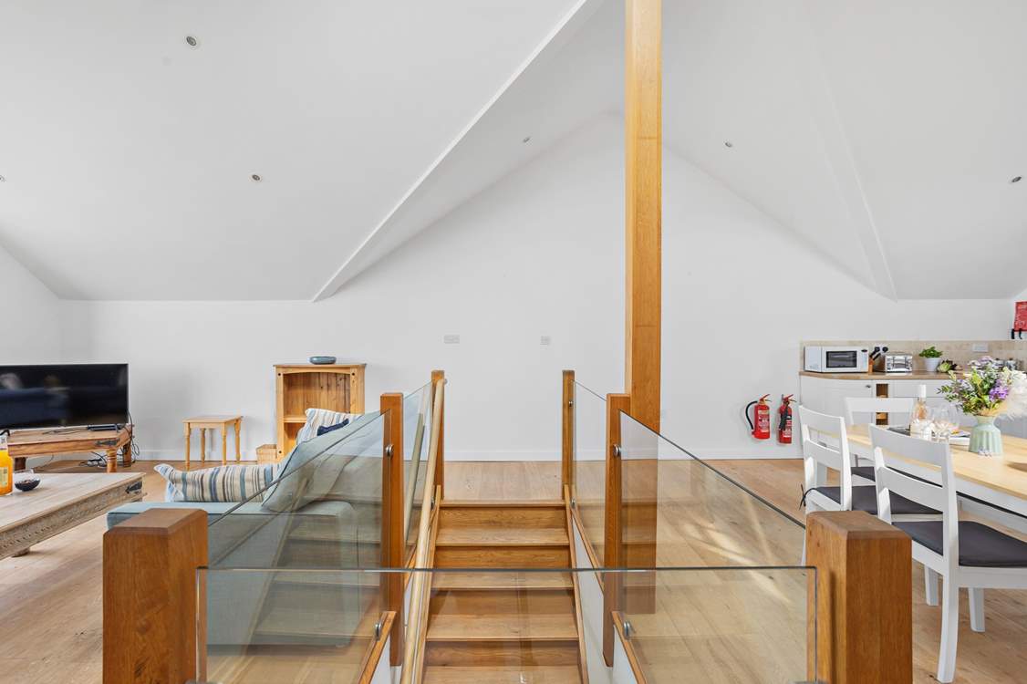 The open plan living area on the first floor is accessed via this lovely wooden staircase.
