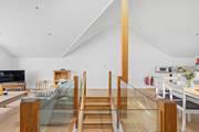 The open plan living area on the first floor is accessed via this lovely wooden staircase.