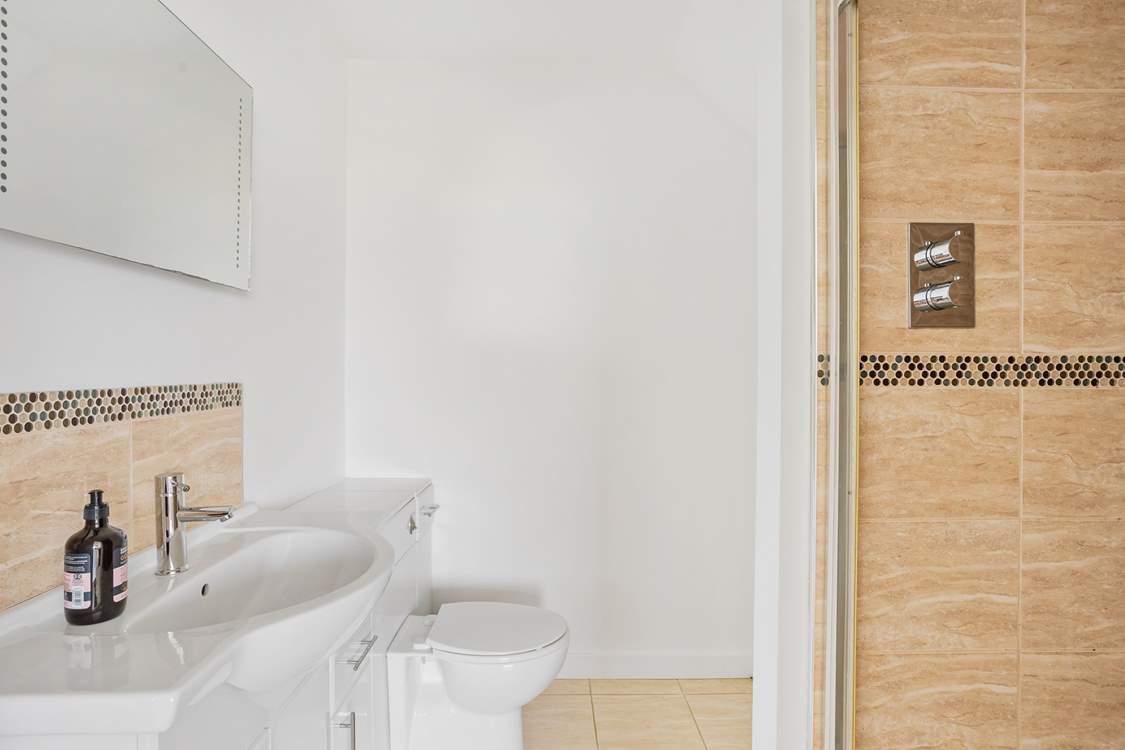 The contemporary en suite shower-room to bedroom 1.