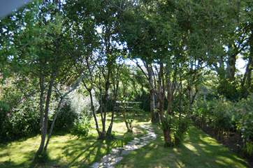 On a hot day, the sheltered little bench under the trees is ideal for morning coffee.