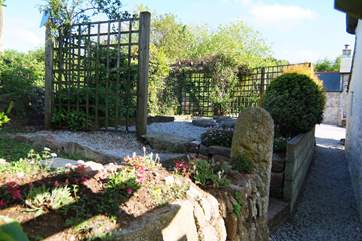 There is also a little raised garden on the other side of the cottage (the owners' house beyond the parking-area is just visible).