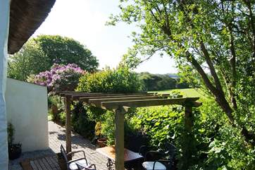 From the raised side garden, stone steps lead back down to the terrace.
