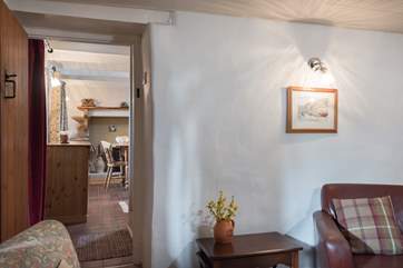 Looking through to the dining-room from the sitting-room, in between are the stairs up to the bedrooms.