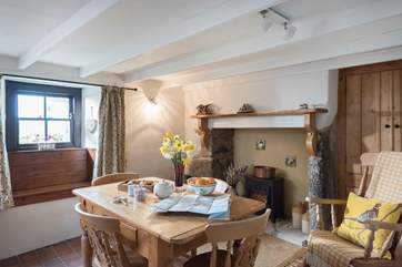 The dining-room has a feature fireplace with an electric stove and a rocking chair.