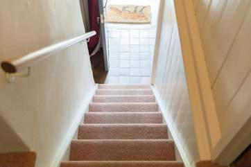 The cottage stairs are typically steep but not narrow and there is a hand rail all the way up to the split landing at the top.