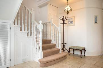 The spacious entrance hall with grand staircase.