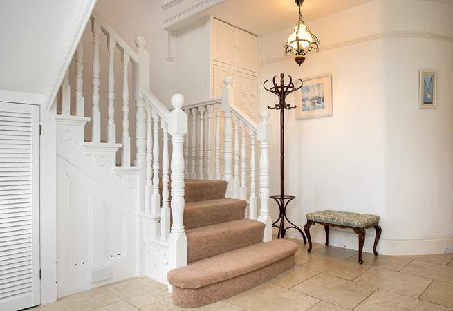 The spacious entrance hall with grand staircase.
