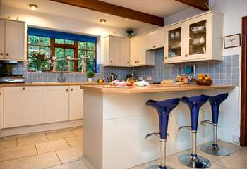 The kitchen has a breakfast-bar, ideal for an informal brunch or a morning coffee.