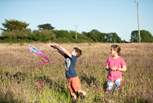 A holiday to remember running through long grass with freedom to explore.