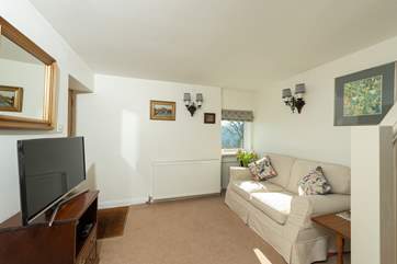 The living-area has a two-seater sofa, as well as a lovely deep armchair.