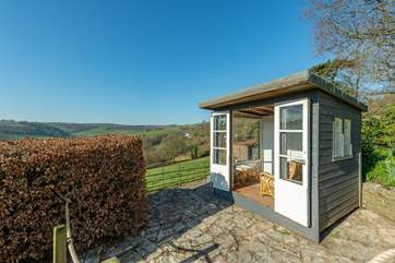 The summer-house is the perfect place to sit with a glass of wine watching the deer come out to graze across the valley.