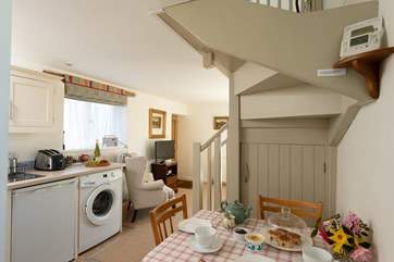 The kitchen is built around two walls, and there is plenty of room for the dining-table.