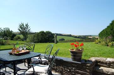 The patio-area outside the cottage catches the sun and offers lovely rural views.