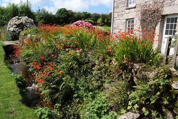 A small leat runs past the cottage.